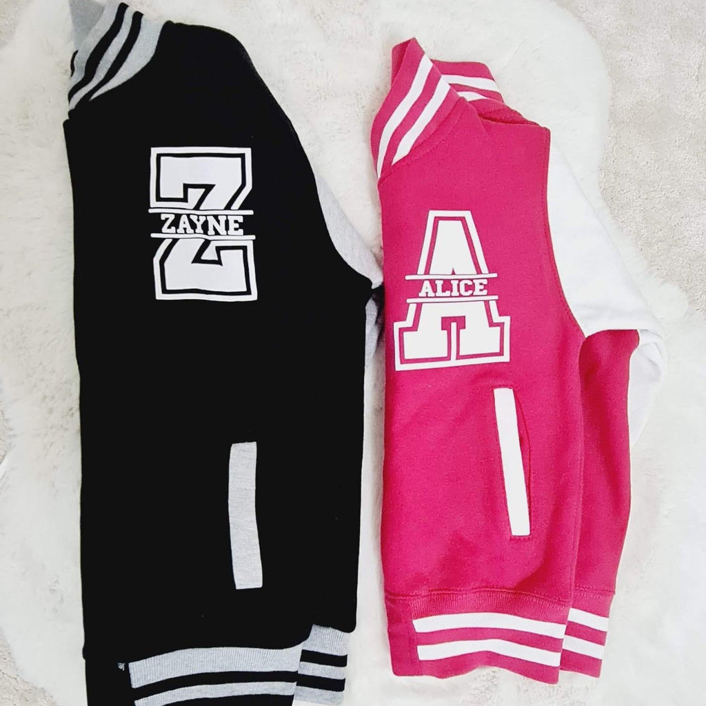 Black and pink shorts with white logo on a white surface