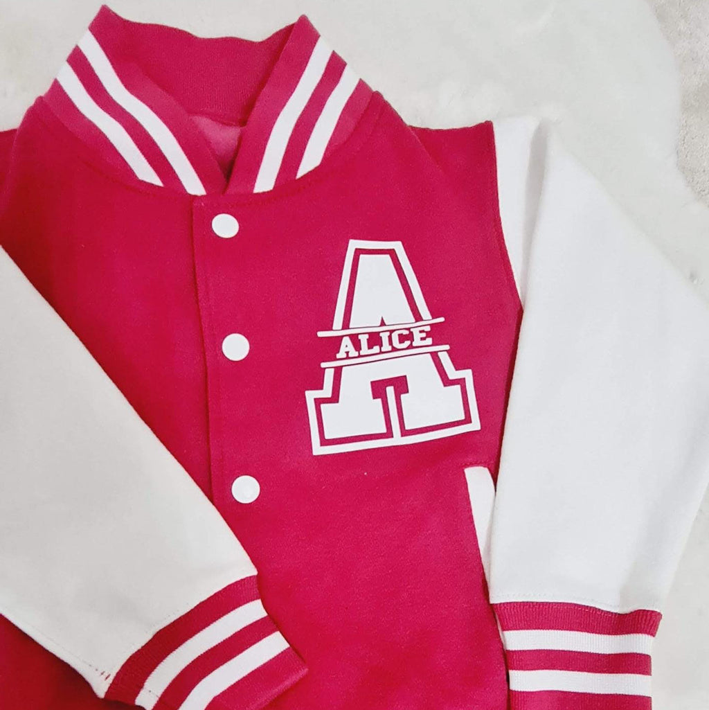 Pink and red varsity-style jacket with white accents on a light background