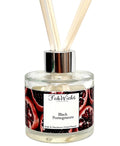 Fragrance diffuser with 'Black Pomegranate' label and wooden sticks on a white background