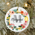 Decorative ornament with floral design and 'M Margaret' text on a Christmas tree.