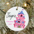 Christmas ornament with pink castle design and 'Jayne Christmas 2021' text on a tree.